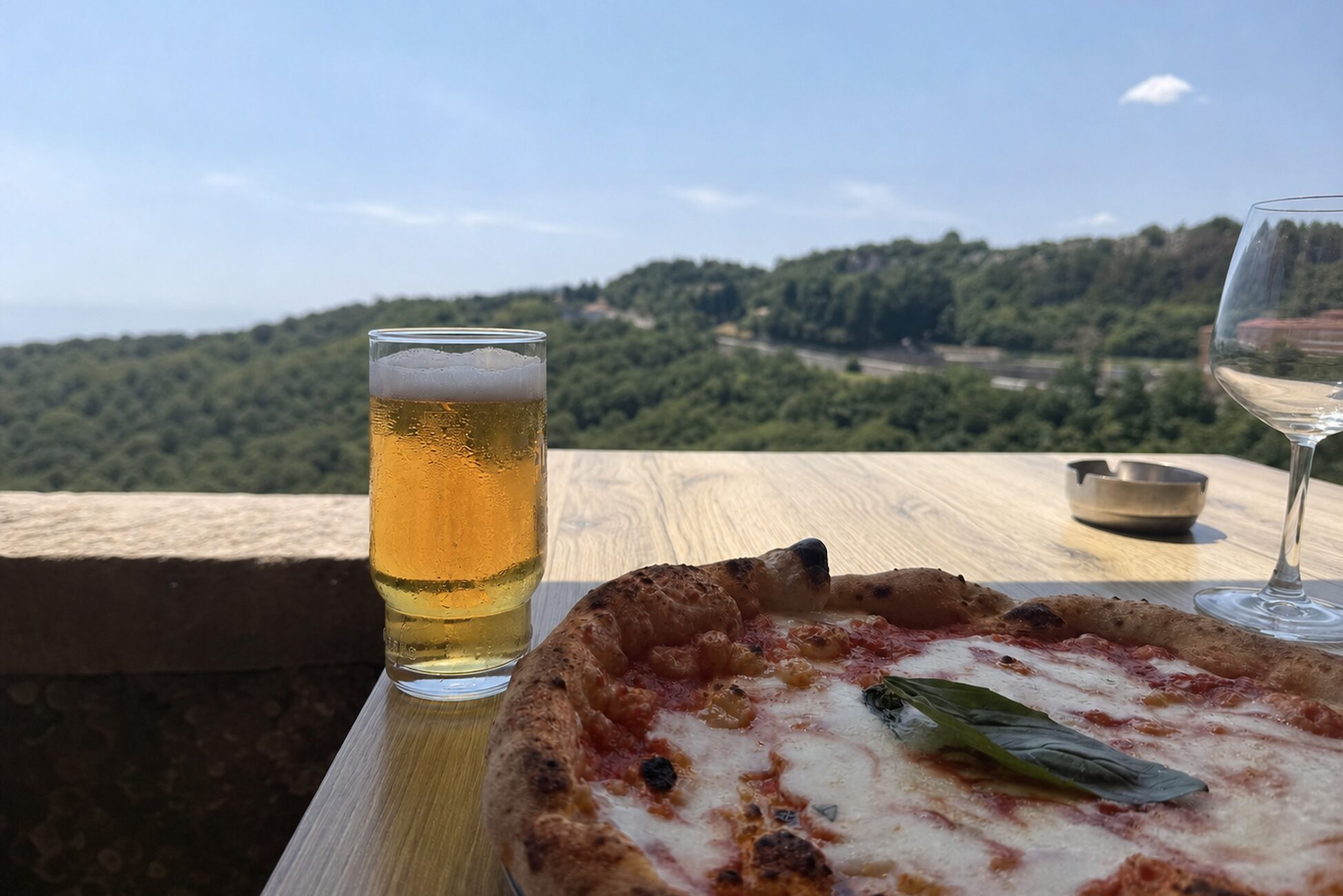 An unhurried meal with a view A simple meal and drinks on a terrace overlooking green eastern Istrian hills