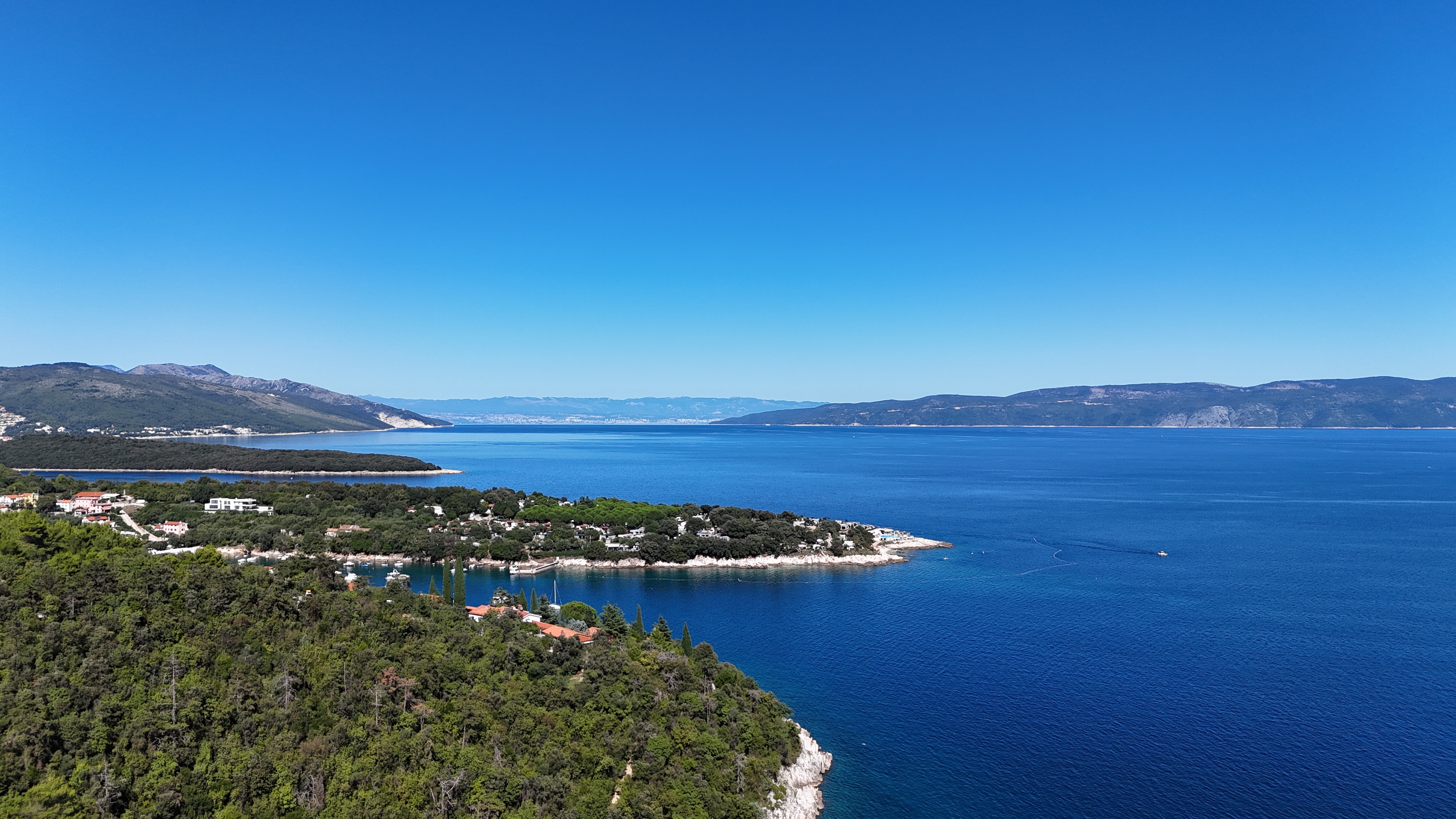 Wide view of the Sveta Marina peninsula Wide view of the Sveta Marina peninsula, wooded coastline and surrounding bay