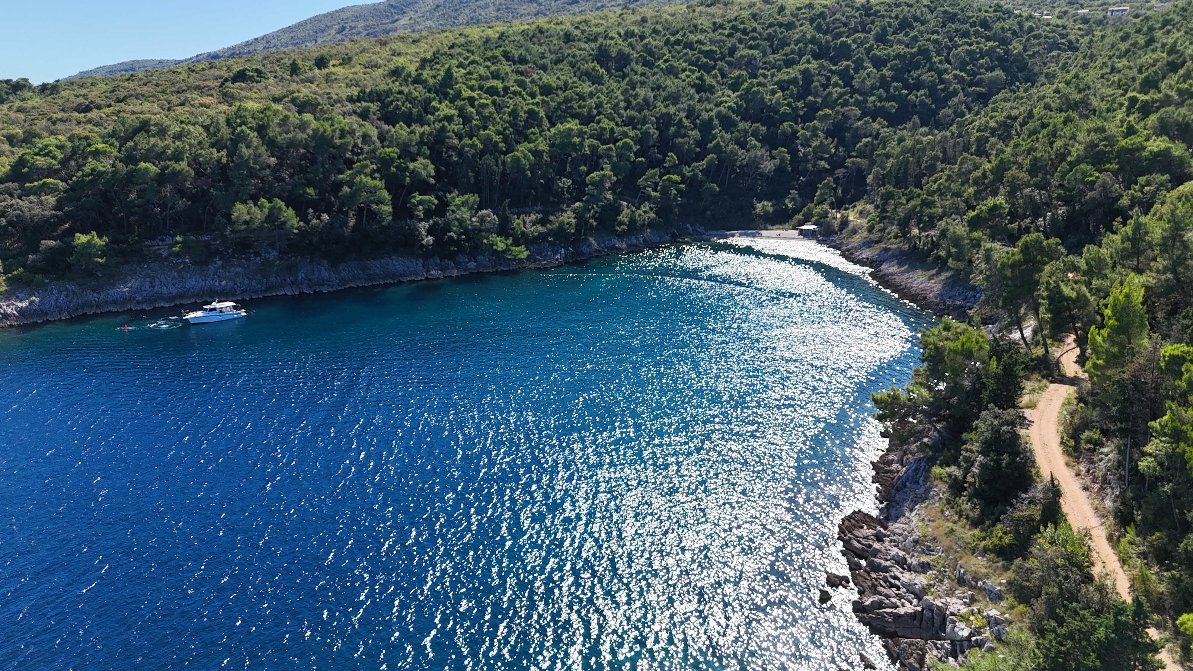 Sheltered cove near Sveta Marina A sheltered blue cove surrounded by forest near Sveta Marina