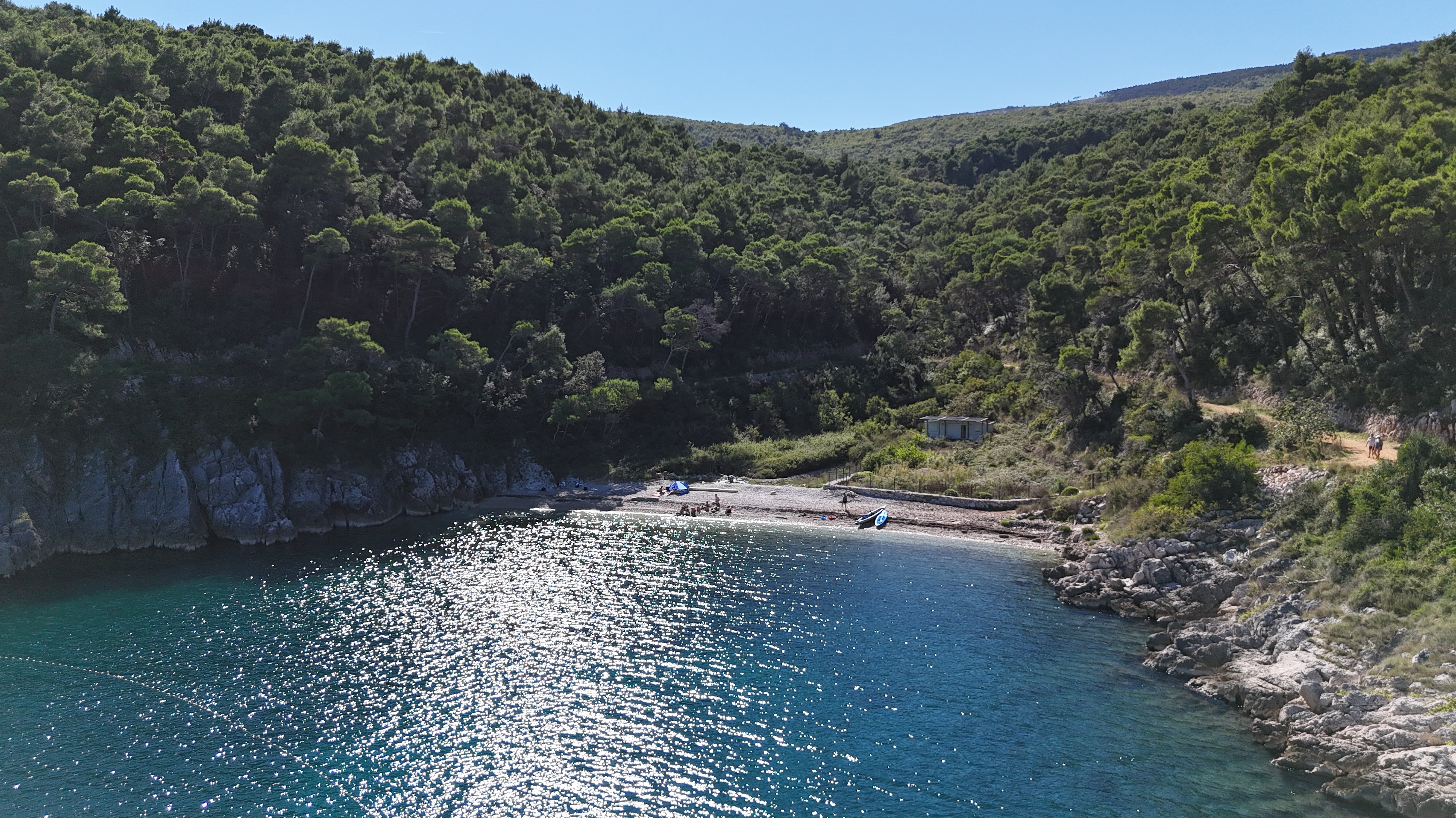 A small cove near Sveta Marina Small pebble cove backed by dense green woodland at Sveta Marina